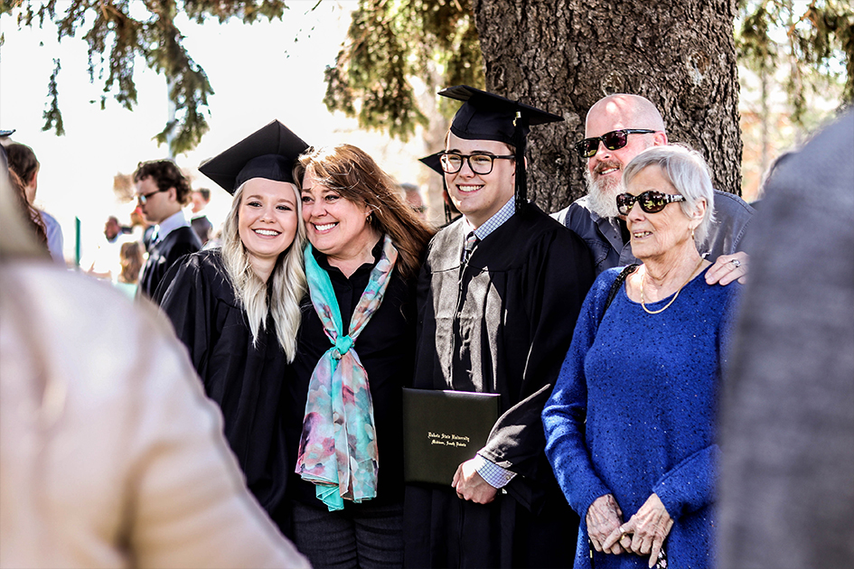 family posing with their graduate