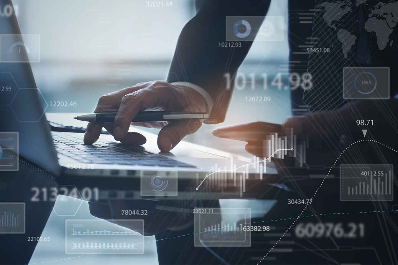 Image of a right hand holding a pen touching the keyboard of a laptop and a left hand holding a phone with an overlay of graphs and numbers on the photo.
